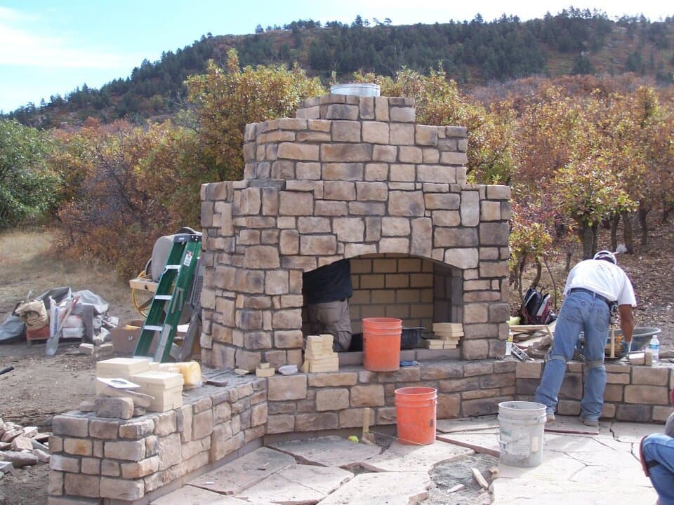 Stone outdoor fireplace under construction