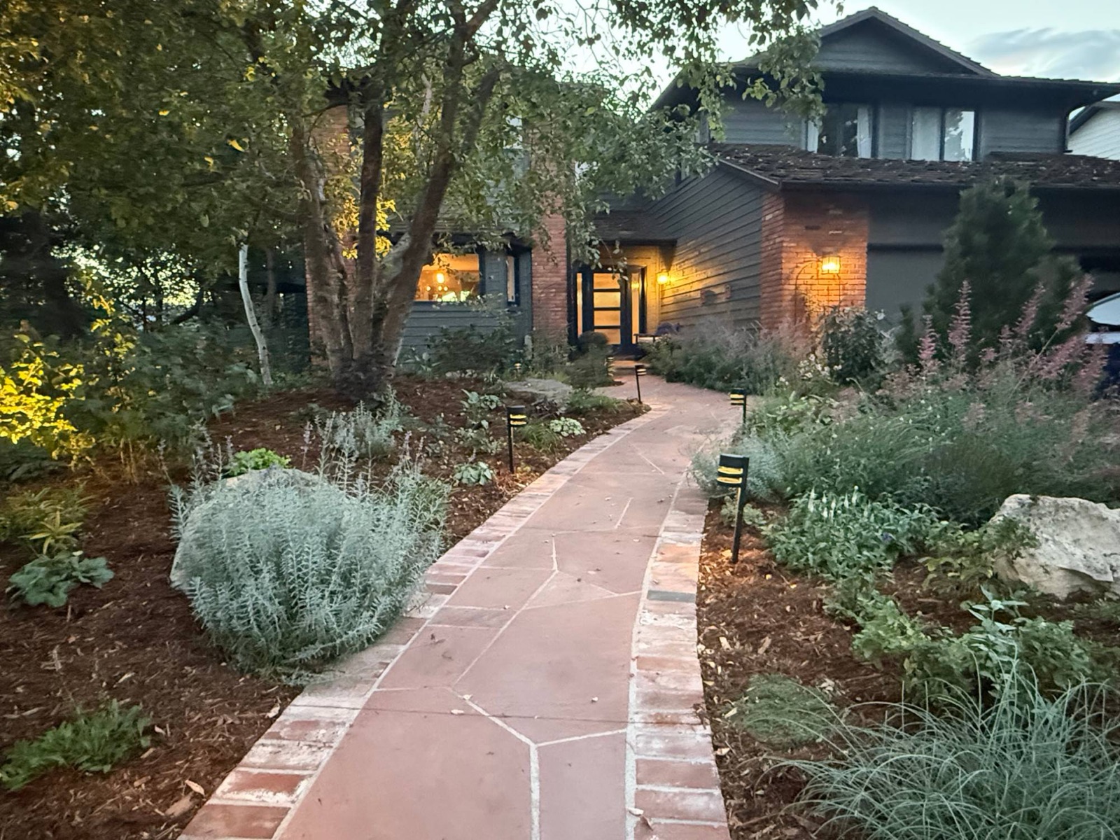 Flagstone front walkway with path lights at dusk