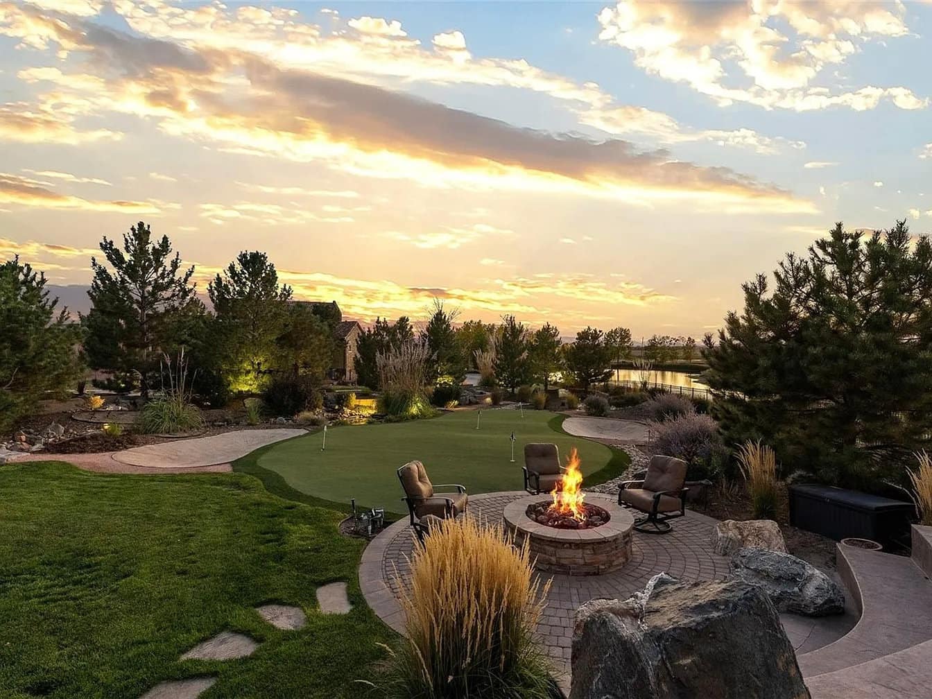 Fire pit beside a putting green at sunset