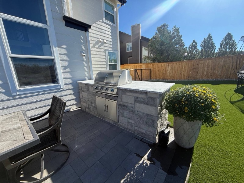 Stacked stone outdoor kitchen with a built in grill
