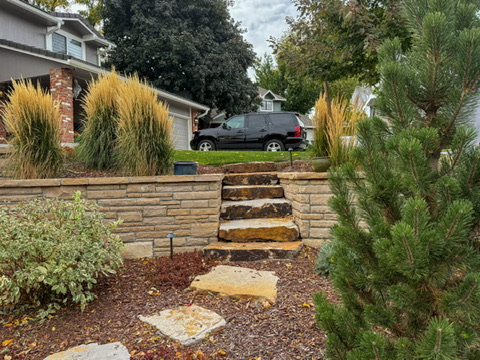 Layered planting beds with ornamental grasses and stone steps
