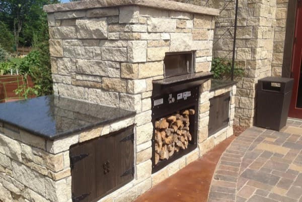 Custom stone outdoor cooking area with built-in storage